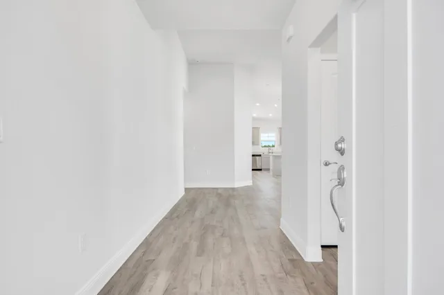 a view of a room with wooden floor