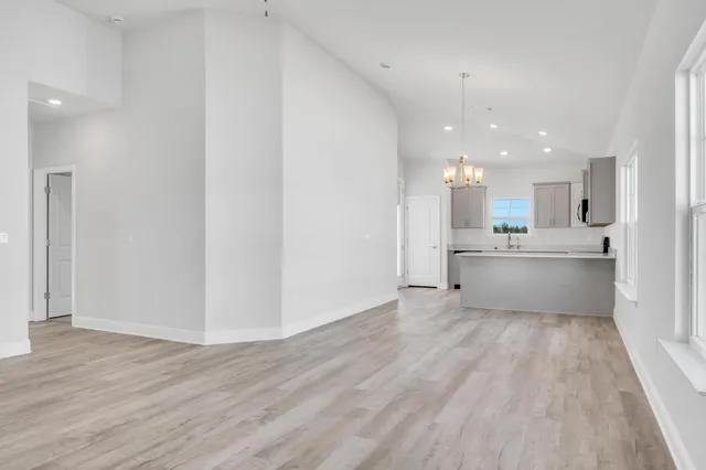 a view of a kitchen with wooden floor and windows
