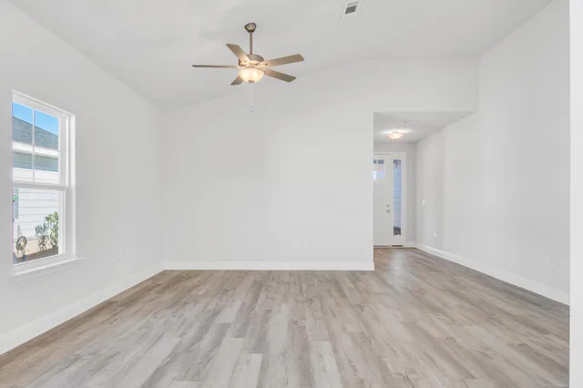 wooden floor in an empty room with a window