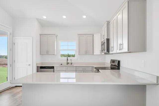a large white kitchen with cabinets