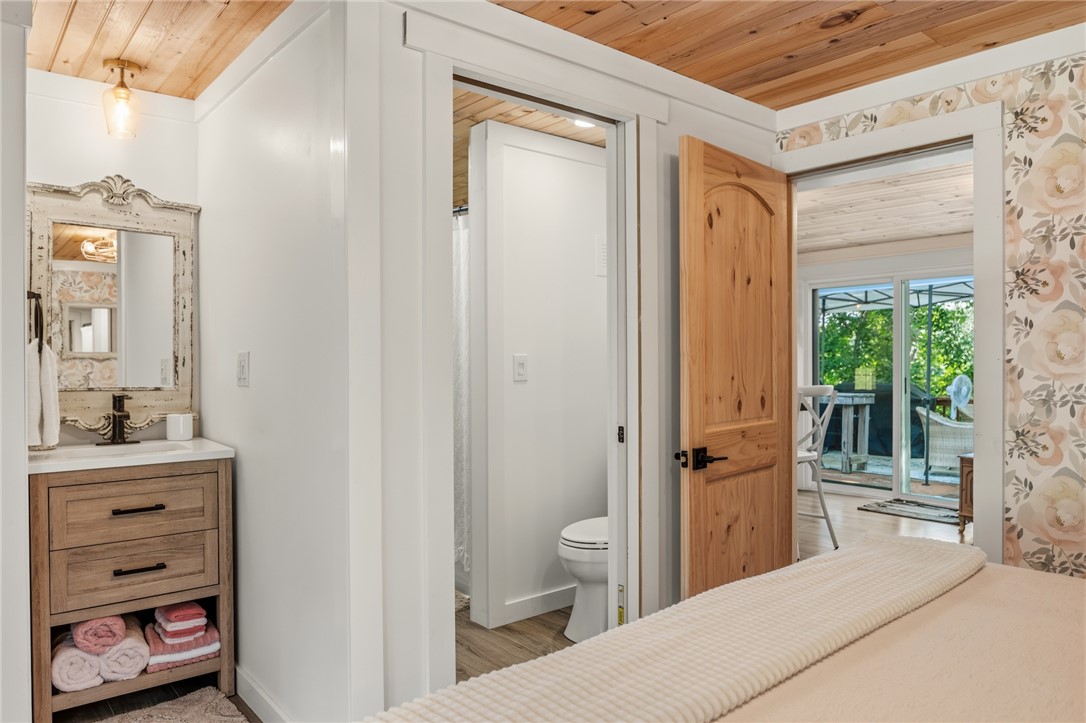 30 Mobleys Bluff Road Abbeville, SC 29620 - Photo 23 of 35 A rustic wood ceiling highlights this suite containing a private vanity area and attached washroom.