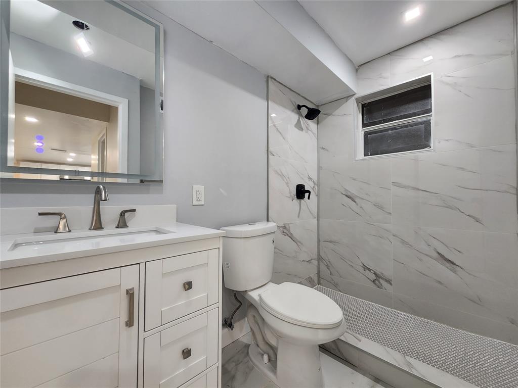 485 North Pine Island Road, Unit 204 Fort Lauderdale, FL 33324 - Photo 7 of 14 a bathroom with a granite countertop toilet sink and mirror