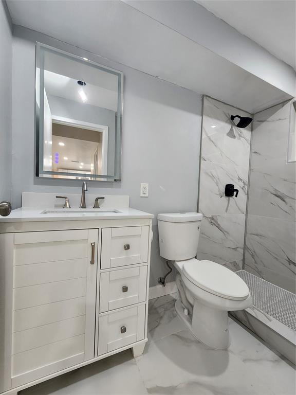 485 North Pine Island Road, Unit 204 Fort Lauderdale, FL 33324 - Photo 8 of 14 a bathroom with a toilet sink vanity and mirror