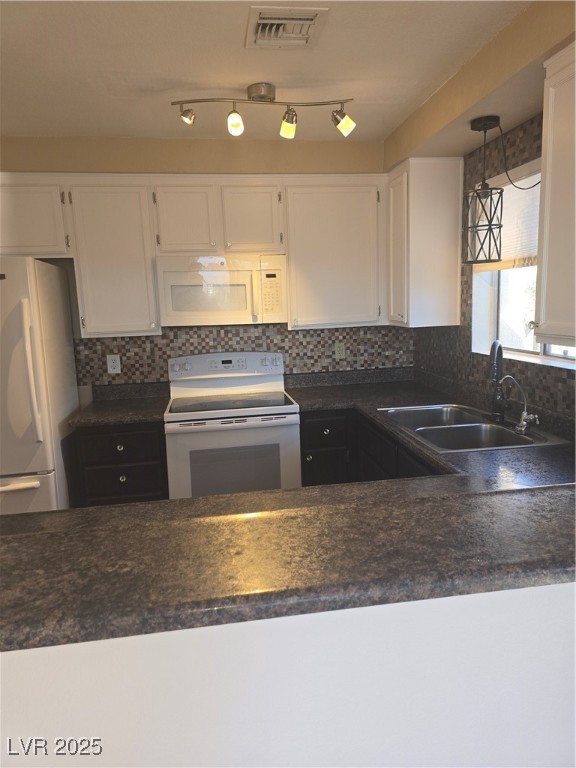 2232 Aspen Mirror Way, Unit 204 Laughlin, NV 89029 - Photo 12 of 37 Kitchen with range, refrigerator, a sink, white cabinets, and dark countertops