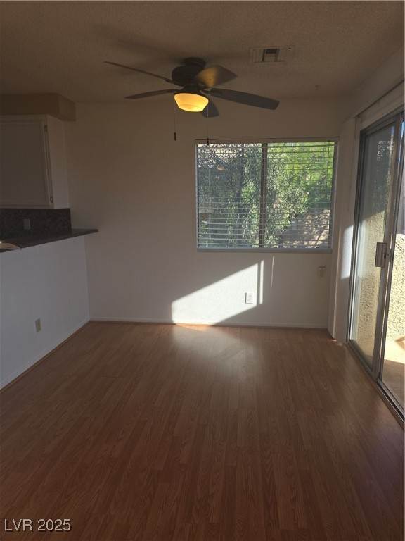 2232 Aspen Mirror Way, Unit 204 Laughlin, NV 89029 - Photo 13 of 37 Unfurnished living room with wood finished floors, a ceiling fan, and baseboards