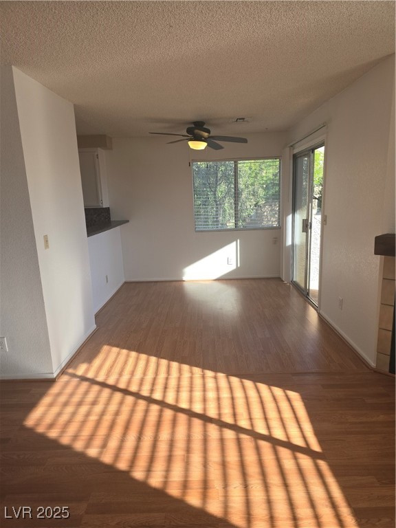 2232 Aspen Mirror Way, Unit 204 Laughlin, NV 89029 - Photo 15 of 37 Unfurnished living room with wood finished floors, a ceiling fan, a textured ceiling, and baseboards
