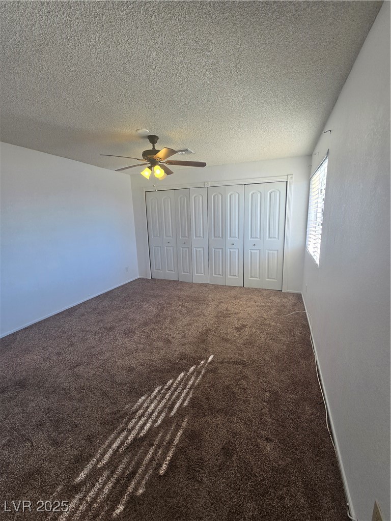2232 Aspen Mirror Way, Unit 204 Laughlin, NV 89029 - Photo 17 of 37 Unfurnished bedroom with carpet flooring, a textured ceiling, and ceiling fan