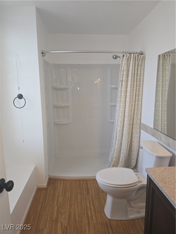 2232 Aspen Mirror Way, Unit 204 Laughlin, NV 89029 - Photo 21 of 37 Bathroom featuring wood finished floors, toilet, a shower with shower curtain, and vanity