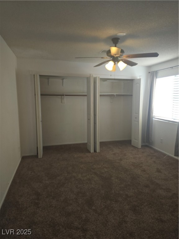 2232 Aspen Mirror Way, Unit 204 Laughlin, NV 89029 - Photo 25 of 37 Unfurnished bedroom featuring multiple closets, carpet floors, a ceiling fan, and baseboards