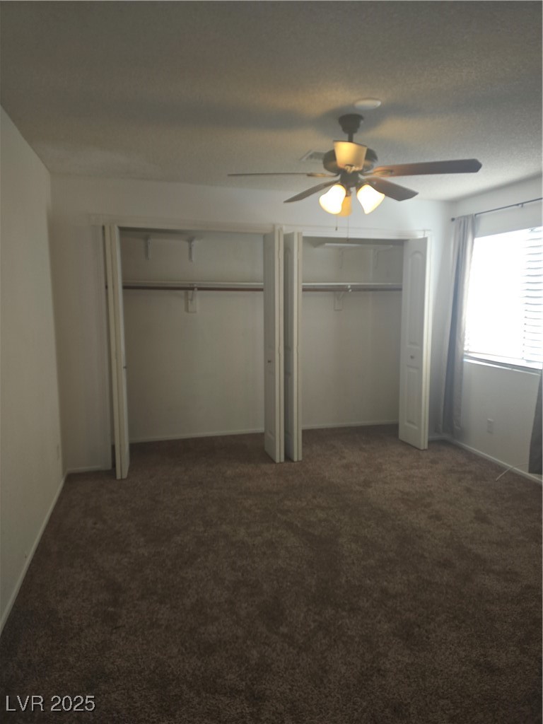 2232 Aspen Mirror Way, Unit 204 Laughlin, NV 89029 - Photo 25 of 37 Unfurnished bedroom featuring multiple closets, carpet floors, a ceiling fan, and baseboards