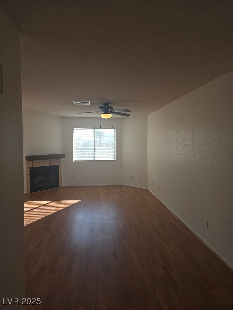 2232 Aspen Mirror Way, Unit 204 Laughlin, NV 89029 - Photo 3 of 37 Unfurnished living room featuring wood finished floors, a fireplace, ceiling fan, and baseboards