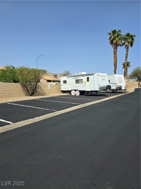 2232 Aspen Mirror Way, Unit 204 Laughlin, NV 89029 - Photo 31 of 37 View of front of property featuring fence and uncovered parking