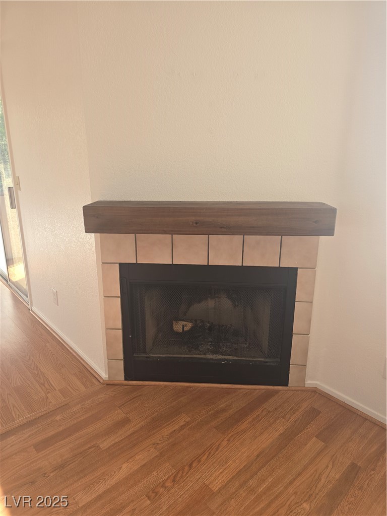 2232 Aspen Mirror Way, Unit 204 Laughlin, NV 89029 - Photo 4 of 37 Detailed view of a tile fireplace, wood finished floors, and baseboards