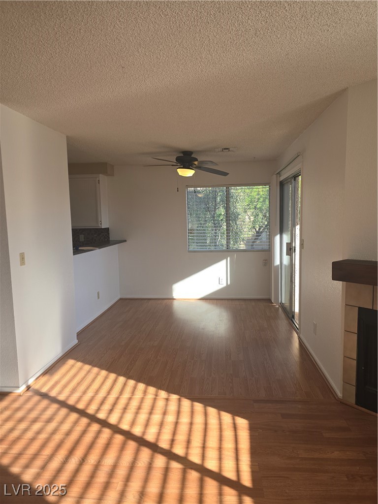 2232 Aspen Mirror Way, Unit 204 Laughlin, NV 89029 - Photo 6 of 37 Unfurnished living room featuring wood finished floors, ceiling fan, a textured ceiling, and baseboards