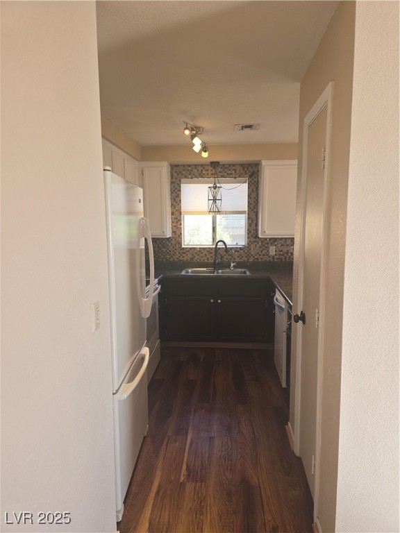 2232 Aspen Mirror Way, Unit 204 Laughlin, NV 89029 - Photo 10 of 37 Kitchen featuring a sink, refrigerator, dark countertops, dark wood-style floors, and tasteful backsplash