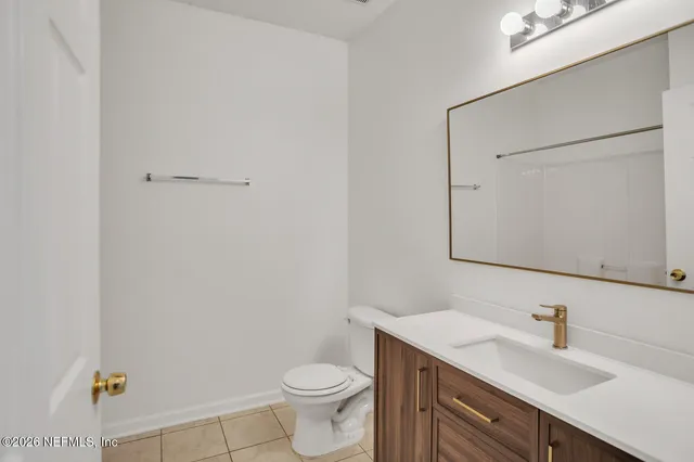 a bathroom with a sink a toilet and mirror