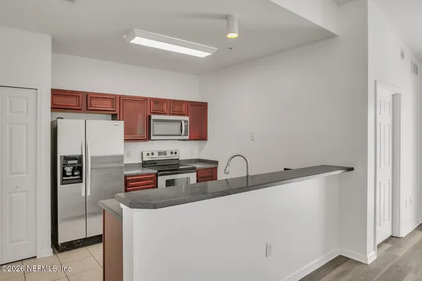 a kitchen with stainless steel appliances a refrigerator and a sink
