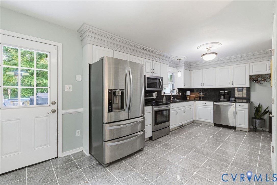 White cabinetry, black countertops, stainless stee