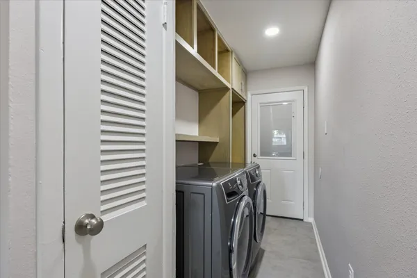a view of a hallway with washer and dryer
