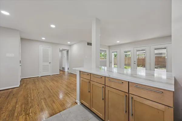 a hallway with white cabinets