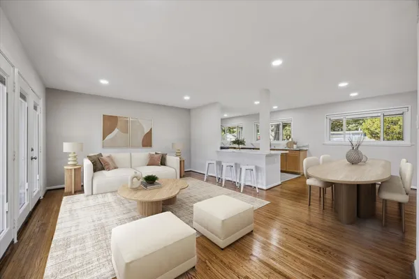 a living room with furniture and a wooden floor