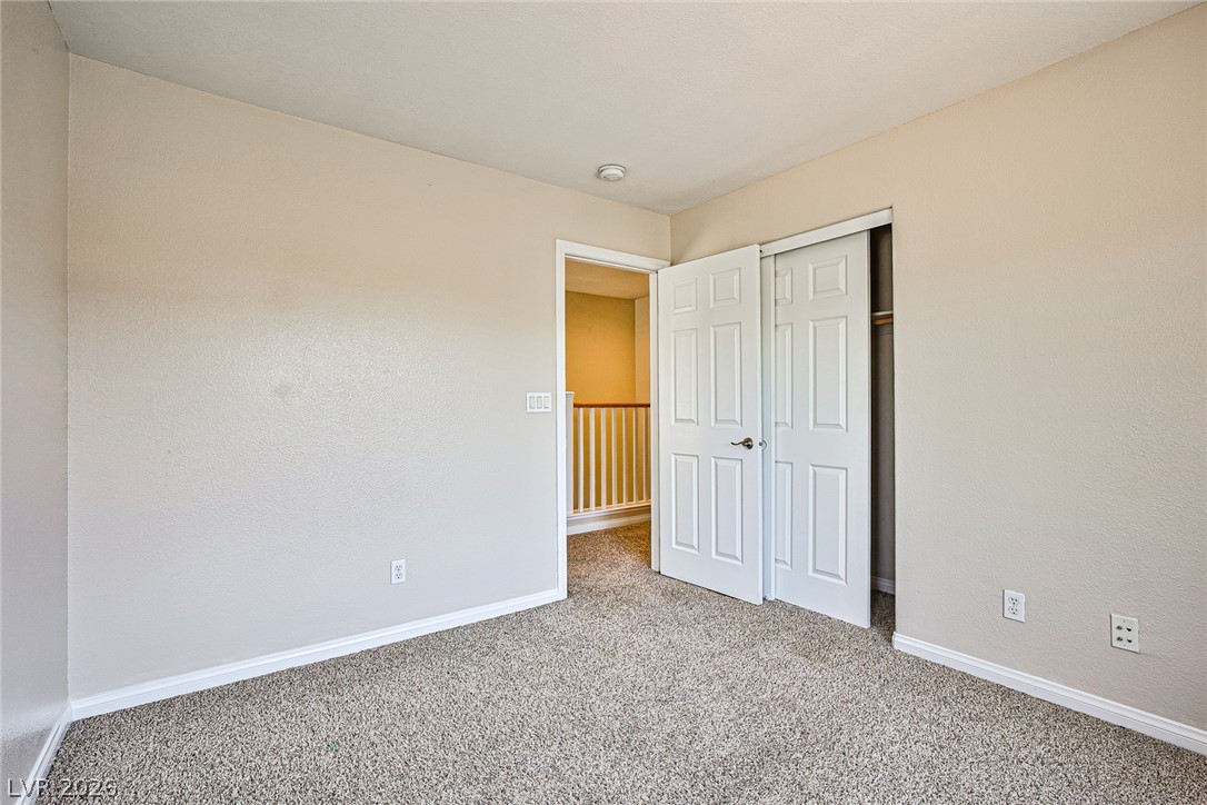 8022 Diamond Gorge Road Las Vegas, NV 89178 - Photo 26 of 37 Soft carpeting pairs with neutral-toned walls and an integrated closet in this upper-level bedroom.