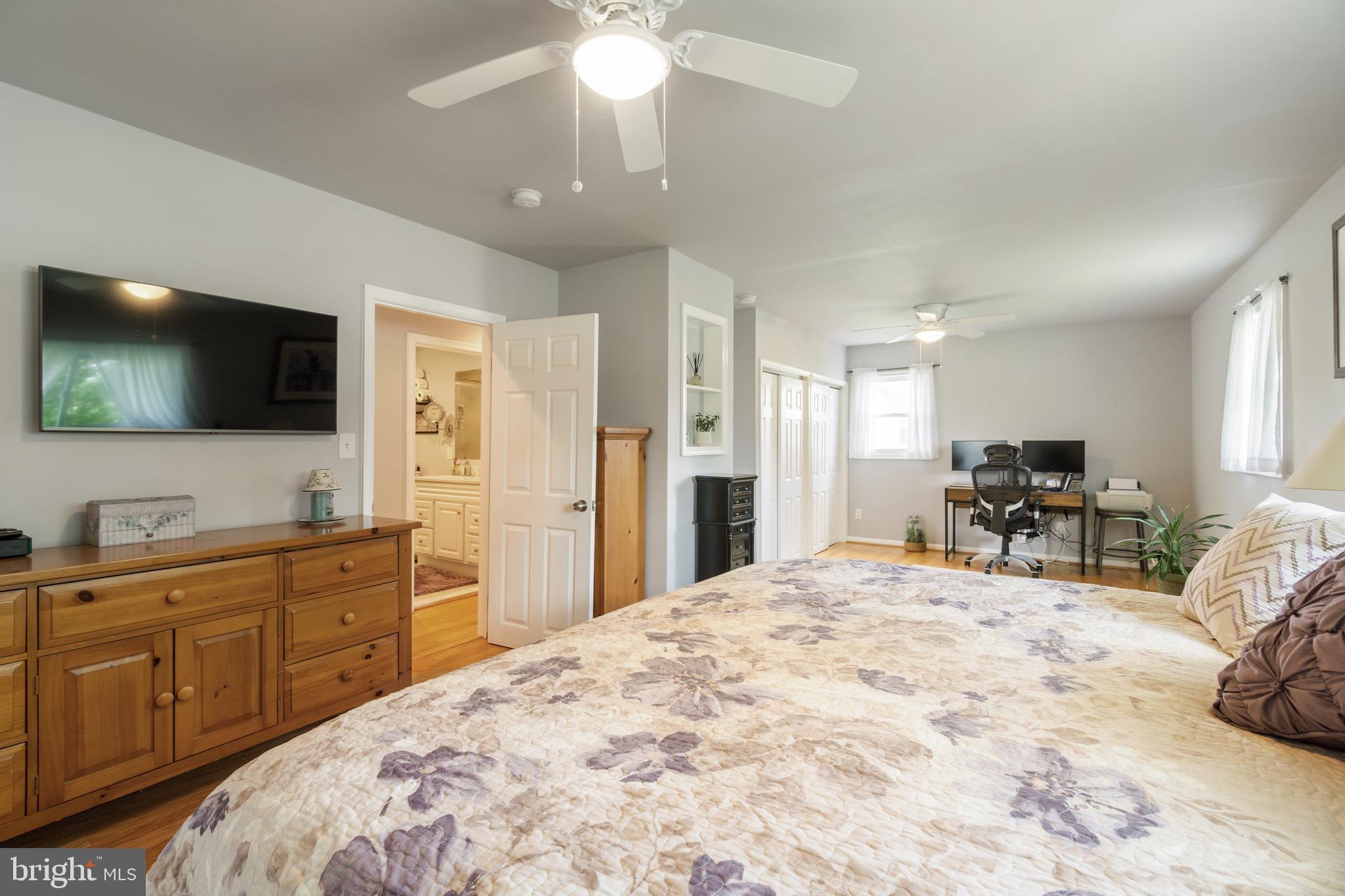 1556 Fairmount Road Hampstead, MD 21074 - Photo 15 of 48 a large bedroom with a bed and a flat tv screen on dresser