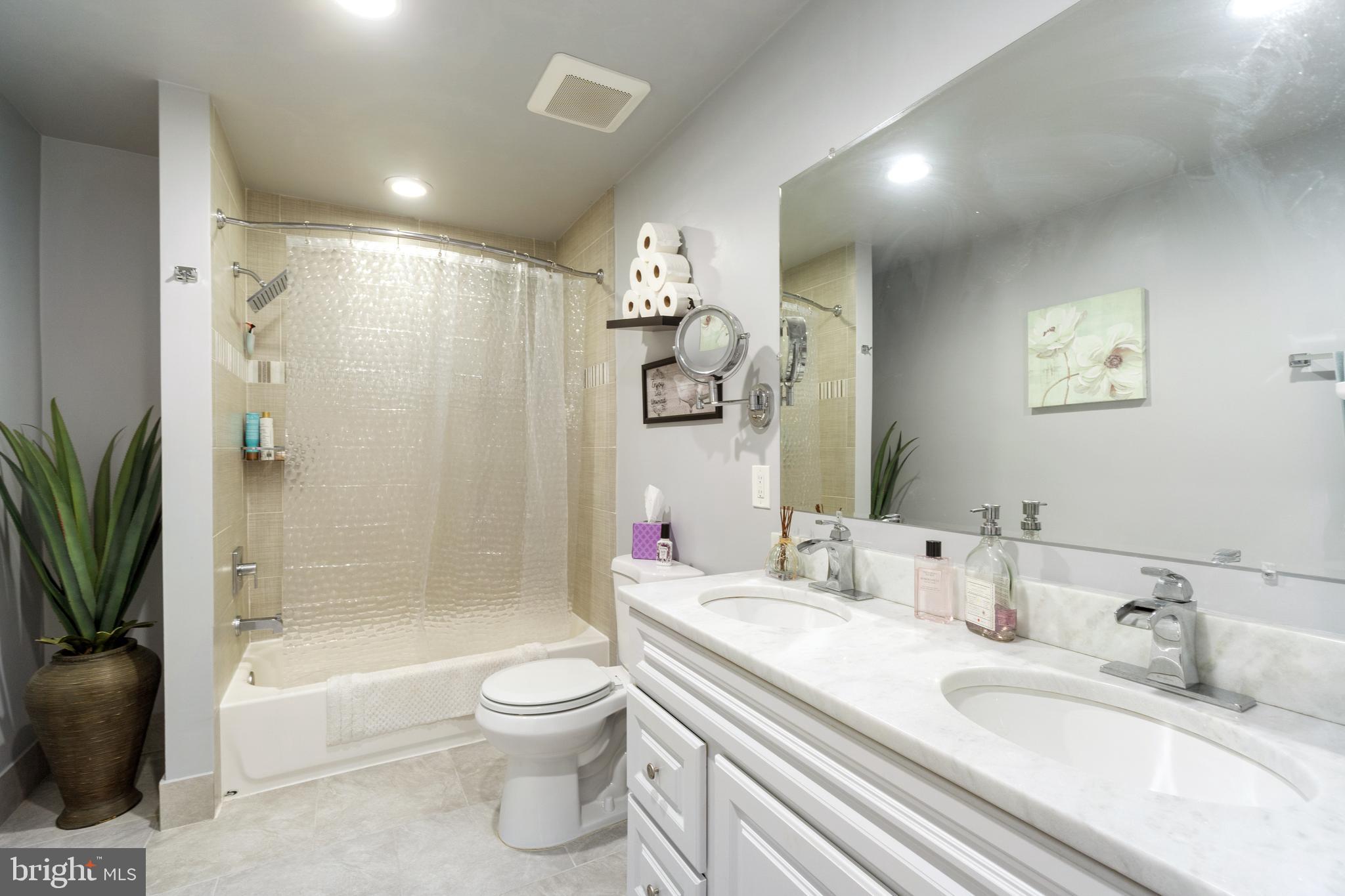 1556 Fairmount Road Hampstead, MD 21074 - Photo 18 of 48 a bathroom with a granite countertop sink toilet a mirror a bathtub and shower