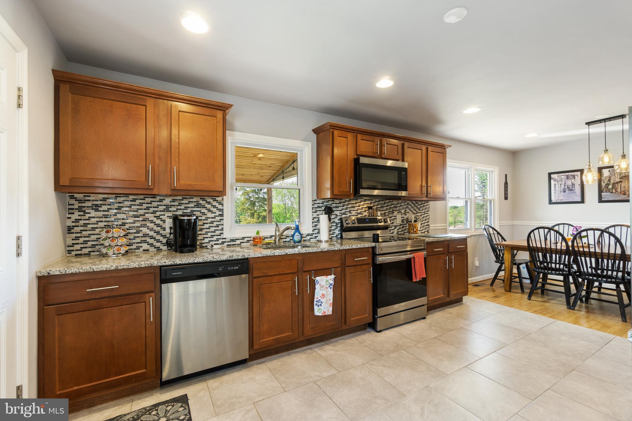 1556 Fairmount Road Hampstead, MD 21074 - Photo 3 of 48 a large kitchen with stainless steel appliances granite countertop a stove sink and cabinets