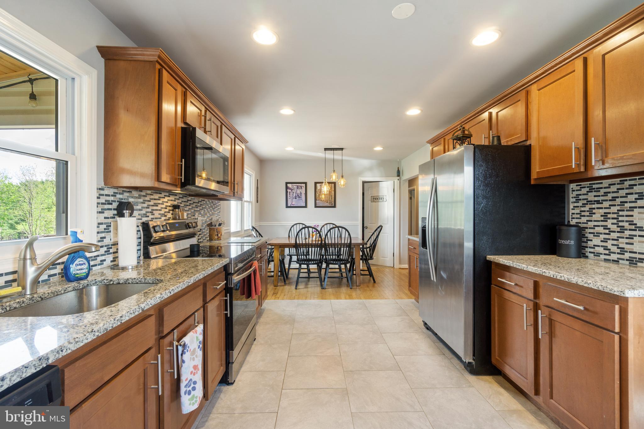 1556 Fairmount Road Hampstead, MD 21074 - Photo 4 of 48 a kitchen with stainless steel appliances granite countertop a refrigerator a sink a stove and a microwave