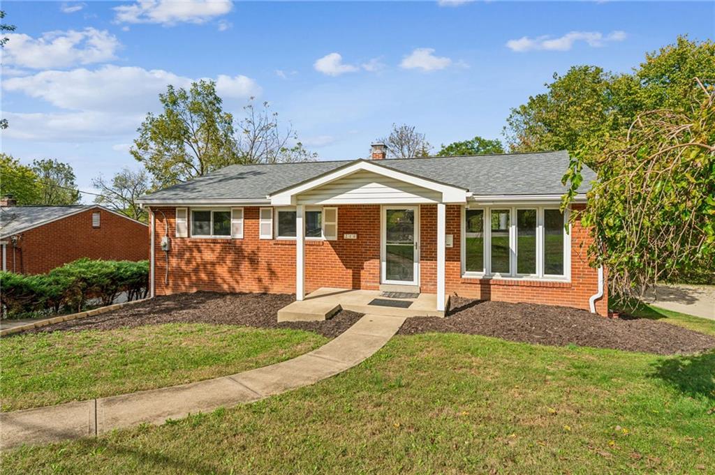 a front view of a house with garden
