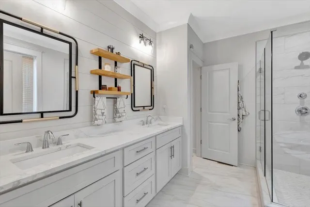 a bathroom with double sink and a mirror