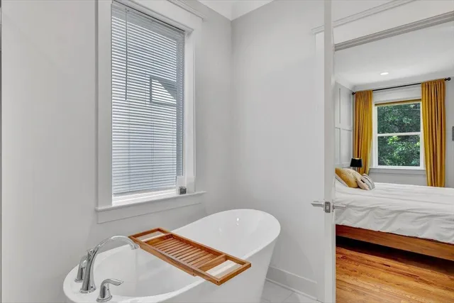 a bathroom with a tub sink and window