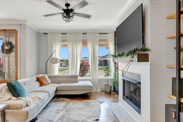 a living room with furniture a fireplace and a chandelier
