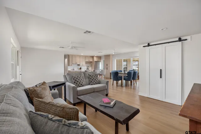 a living room with furniture and a wooden floor