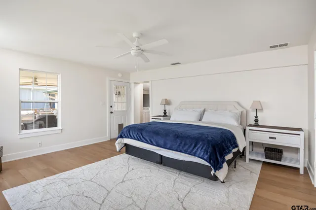 a bathroom with a double vanity sink toilet and mirror