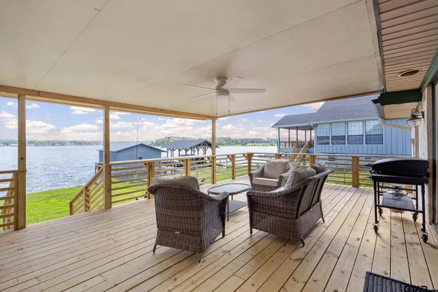 a balcony with furniture and wooden floor