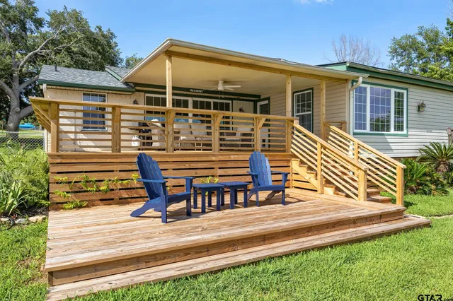 a view of a house with backyard and sitting area