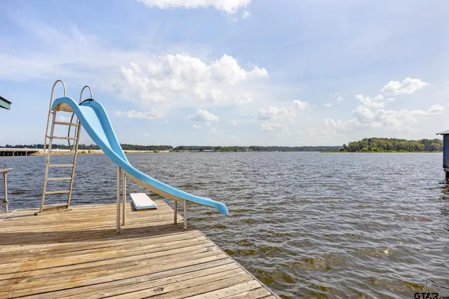 a swimming pool with outdoor seating and yard
