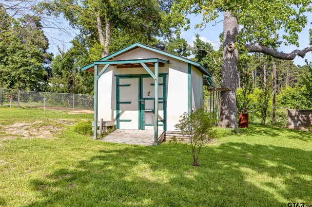 a view of a house with a yard balcony and sitting area