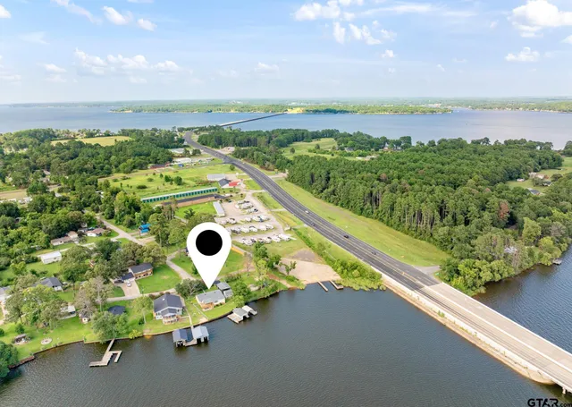 an aerial view of a house with a backyard space
