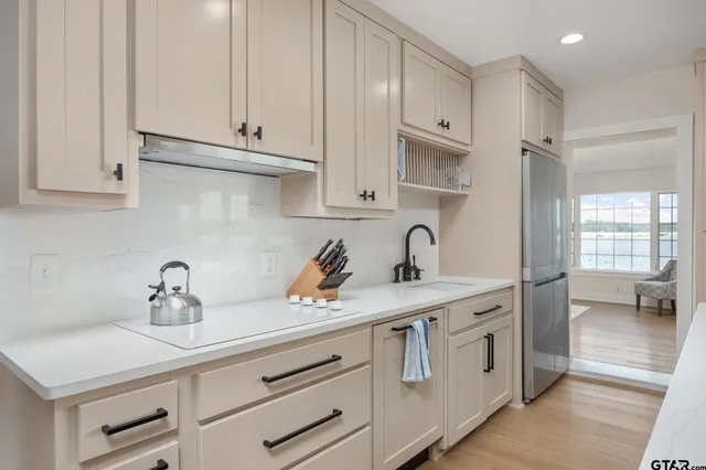 a kitchen with cabinets appliances a sink and a counter top space