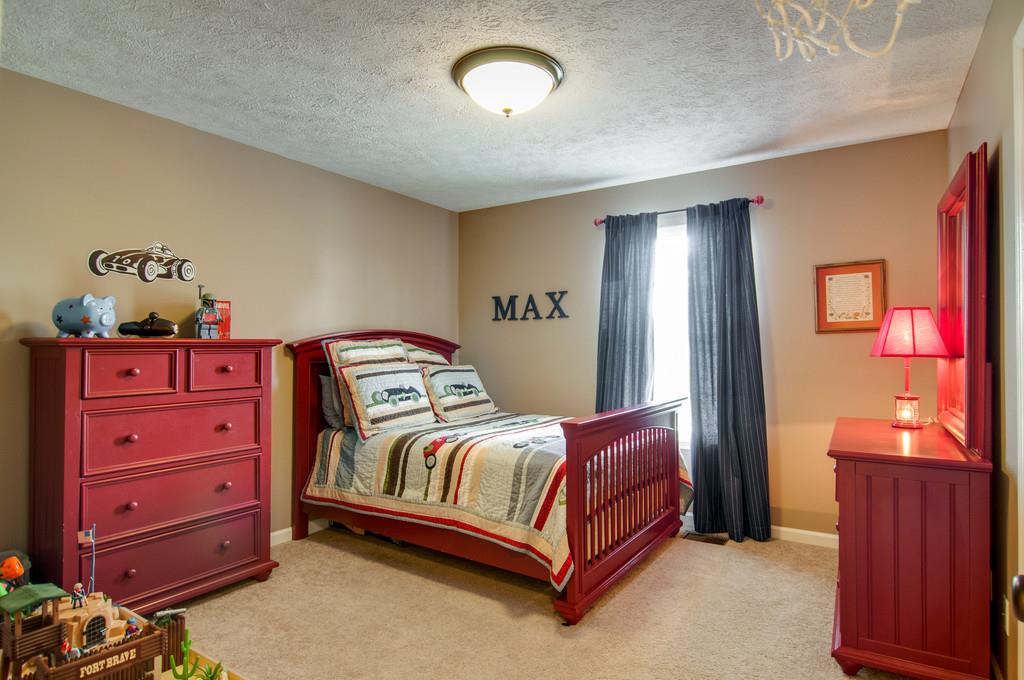 774 Blakemore Road Dickson, TN 37055 - Photo 14 of 25 a bedroom with a bed and a dresser