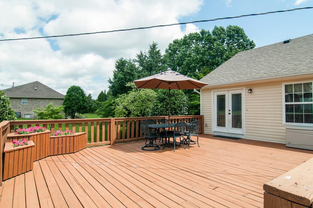 774 Blakemore Road Dickson, TN 37055 - Photo 22 of 25 a balcony with wooden floor table and chairs
