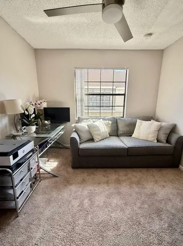 a view of a house with backyard and a tree