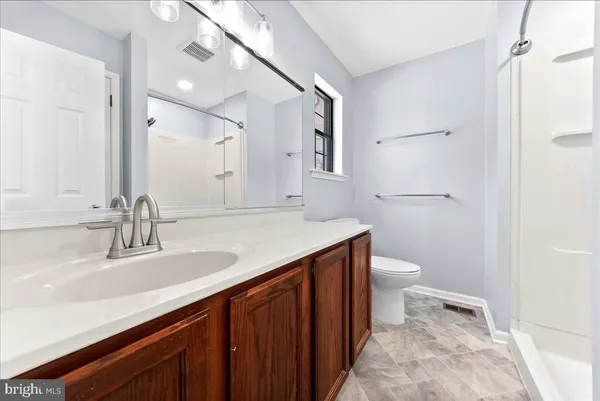 a bathroom with a sink a toilet and a mirror