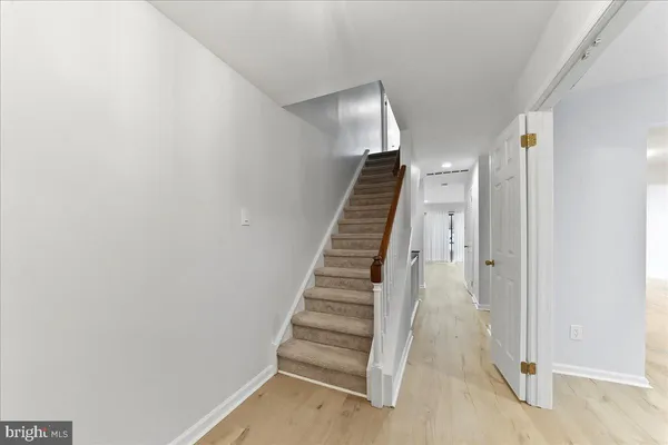 a view of entryway and hall with wooden floor