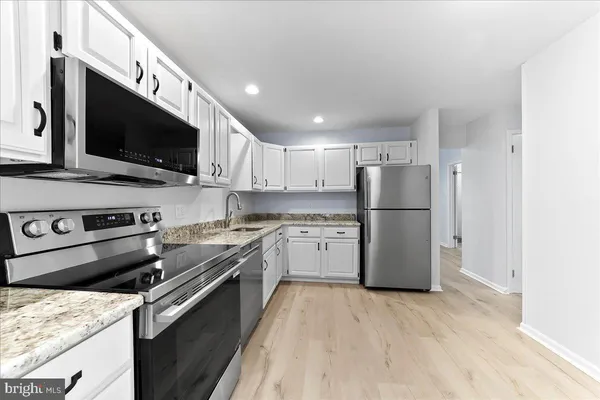 a kitchen with a refrigerator stove and microwave