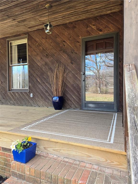 1077 Flat Shoals Road King, NC 27021 - Photo 4 of 46 Wood siding with new decking on wrap around porch.