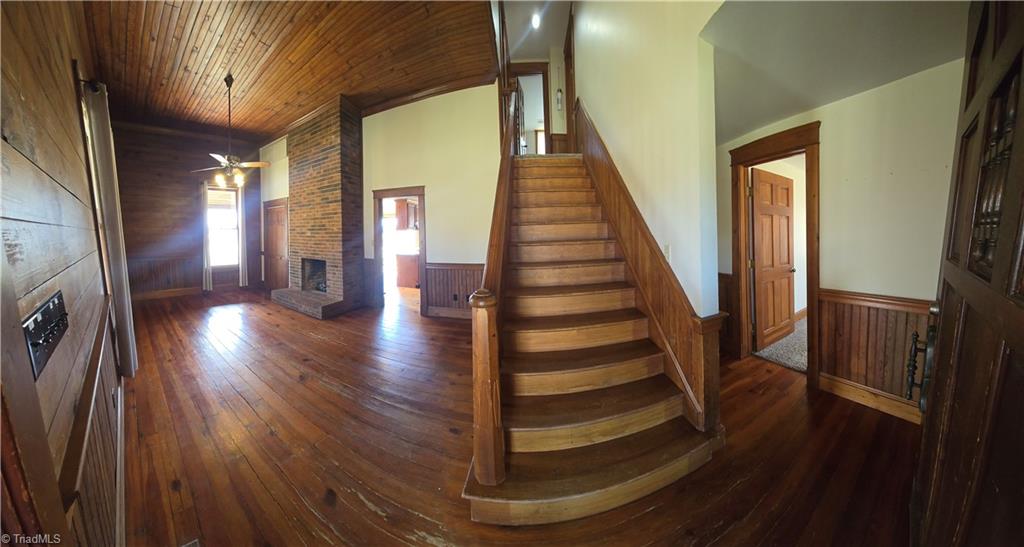 1077 Flat Shoals Road King, NC 27021 - Photo 8 of 46 Elements of the original structure were saved and used in the remodel. Kitchen door beside the fireplace and second bedroom on first floor can be seen on the right.
